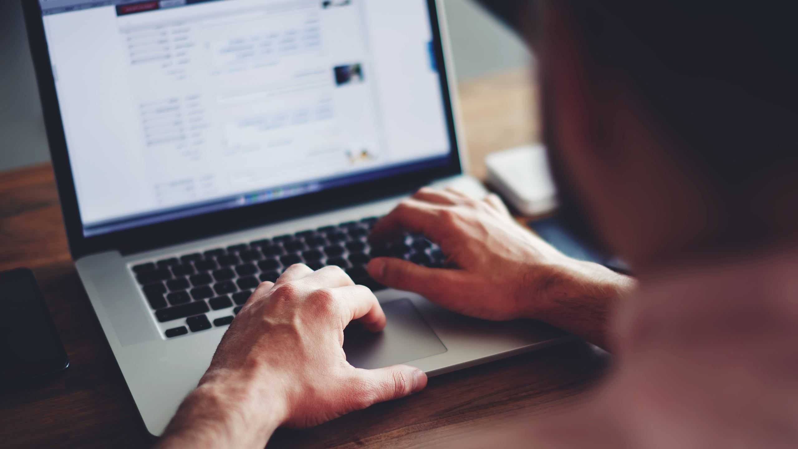 hands typing on a laptop